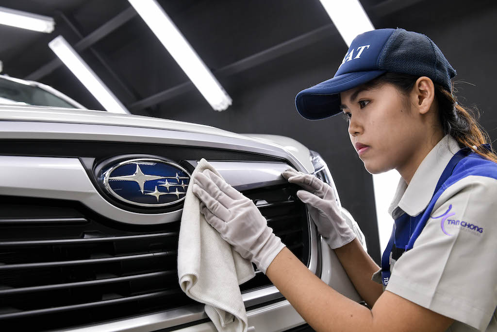4. Subaru staff carefully polishing the vehicle
